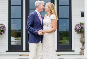 Bride and groom holding hands looking at each other