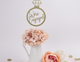 'We're engaged' glittery gold ring shaped engagement party center piece