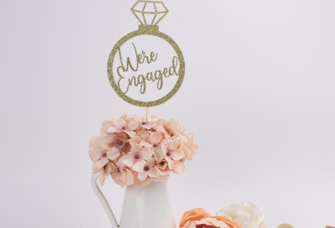 'We're engaged' glittery gold ring shaped engagement party center piece