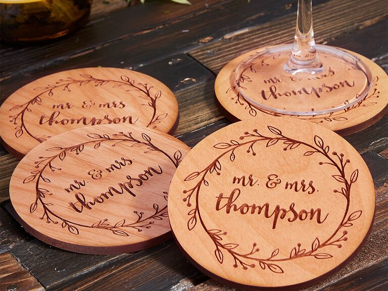'Mr. & Mrs. surname' bordered by wreath engraved into circular wooden coaster