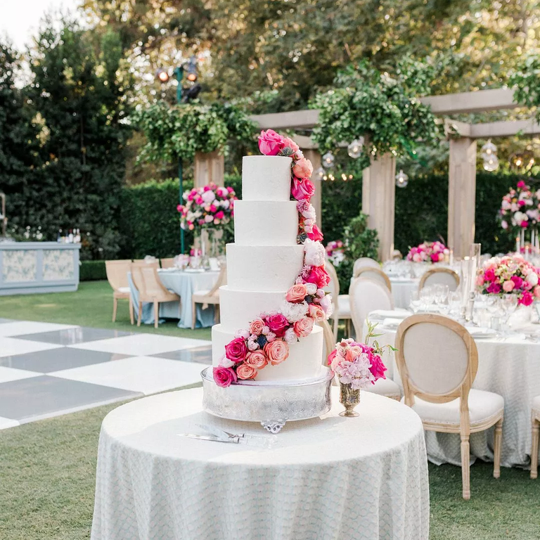 White tiered wedding cake with pink roses