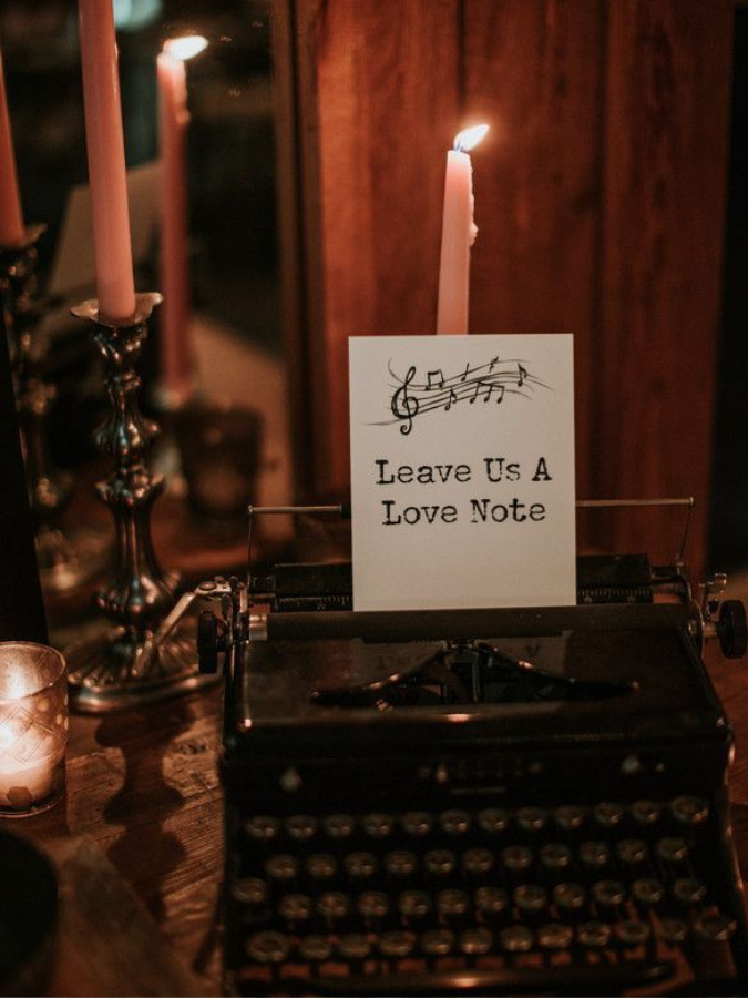 typewriter surrounded by taper candles