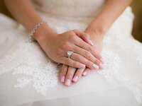 bride wearing engagement ring and bracelet on wedding day