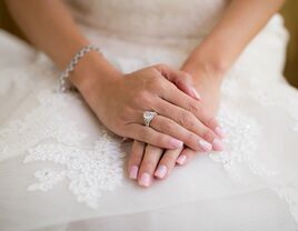 bride wearing engagement ring and bracelet on wedding day