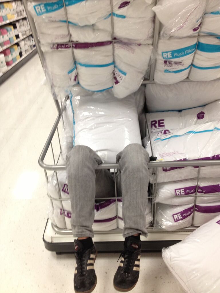 Joe hides in a pillow bin at Target on one of many trips to pick up college-student supplies (read: more tide pods). 