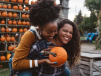 Couple enjoying pumpkin patch together, halloween date ideas