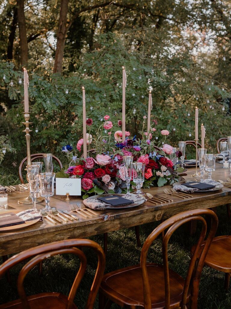 Tall tapered candles in floral arrangement