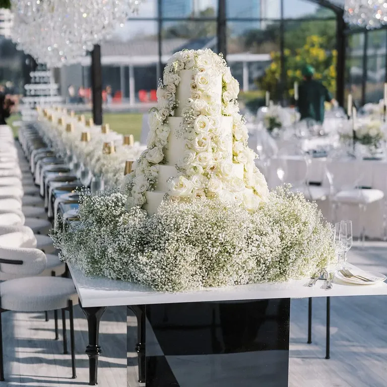 Multi-tiered white wedding cake with roses, taylor swift themed wedding 