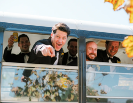 Groomsmen on a bus wearing wedding day tuxedos