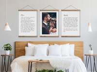Three hanging frames with photo in center, vows in black type on white canvas sign