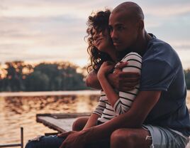 Couple embracing each other and smiling.