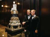 Couple cutting their ornate wedding cake