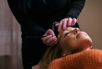 Bride having eyebrows microbladed before wedding