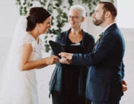 Bride and groom and officiant at wedding ceremony