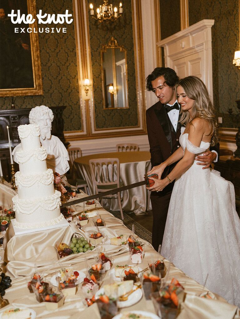 Logan Rae Hill and her husband Joey Kurbanov slicing into their wedding cake with a sword