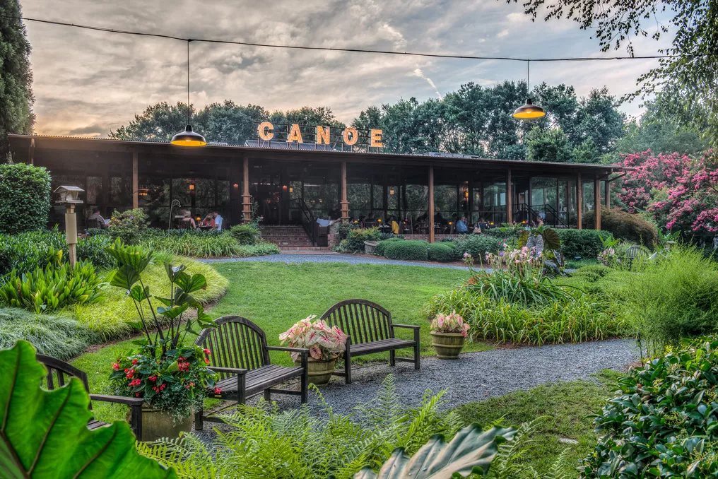 The sun sets on the tranquil setting of Canoe, where benches wait for visitors to stay awhile.