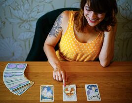 Tarot card reader with her deck of cards