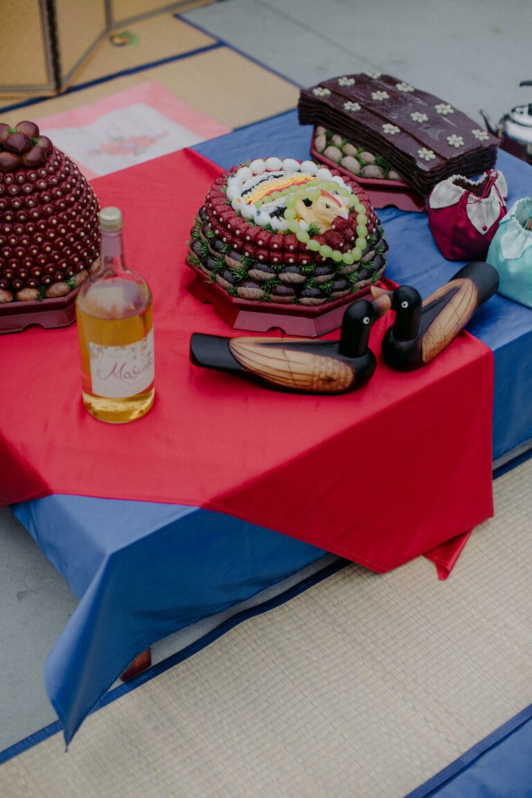 pye-baek table with wine and wood geese