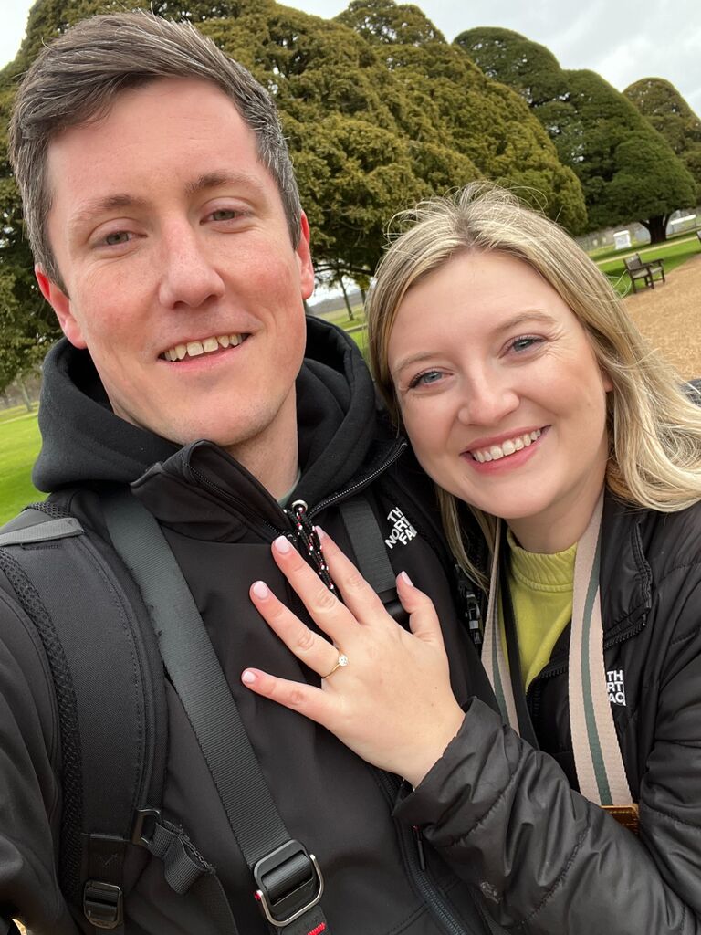 Alex and Lily were able to take a vacation to England, where Alex's dad is from. Lily got to meet Alex's grandmother and the English side of his family for the first time. While going on more day trips, Alex took Lily to a castle and popped the question! They were both glad to spend time with his family and create lasting memories. They cannot wait to celebrate with everyone to create more on their special day!