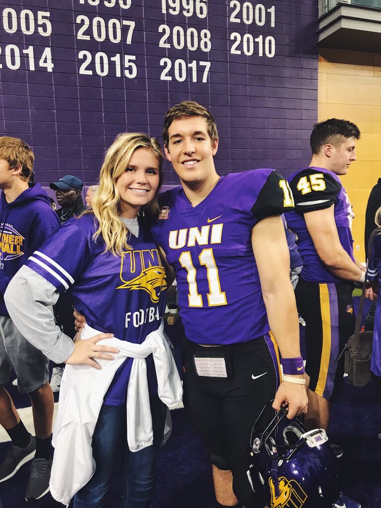They met at the University of Northern Iowa where Colton played football and Delaney played volleyball. Colton asked Delaney to be his girlfriend in front of the Keeper of the Plains in Wichita, KS after their first official date at Bella Vita. They try and go back once a year to celebrate!