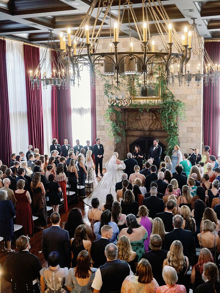 Wedding ceremony in front of grand fireplace