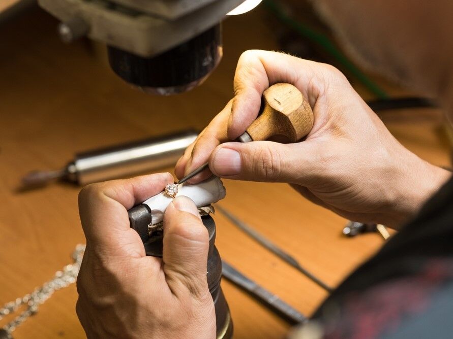 Man fixing a diamond in his workshop