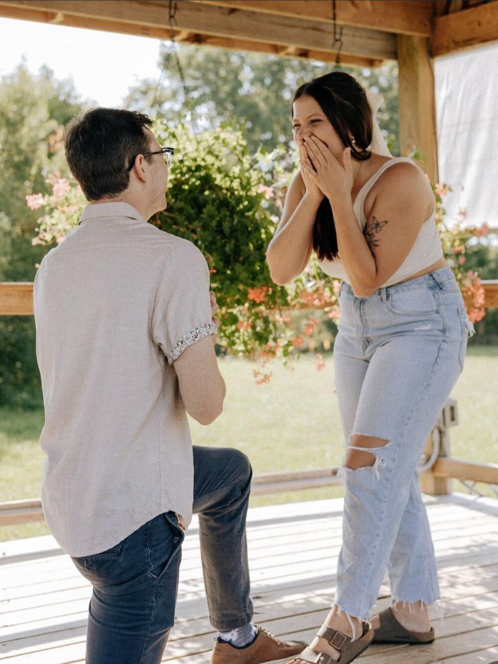Seth popped the question at Crazy Daisies Flower Farm in Syracuse and surprised Taylor with his family and their closest friends!
(Fun fact: Taylor had a gut feeling it was about to happen and insisted on getting a mimosa to calm her nerves first, so the photographer missed when he actually got down on one knee! The photographer had us recreate the moment after).