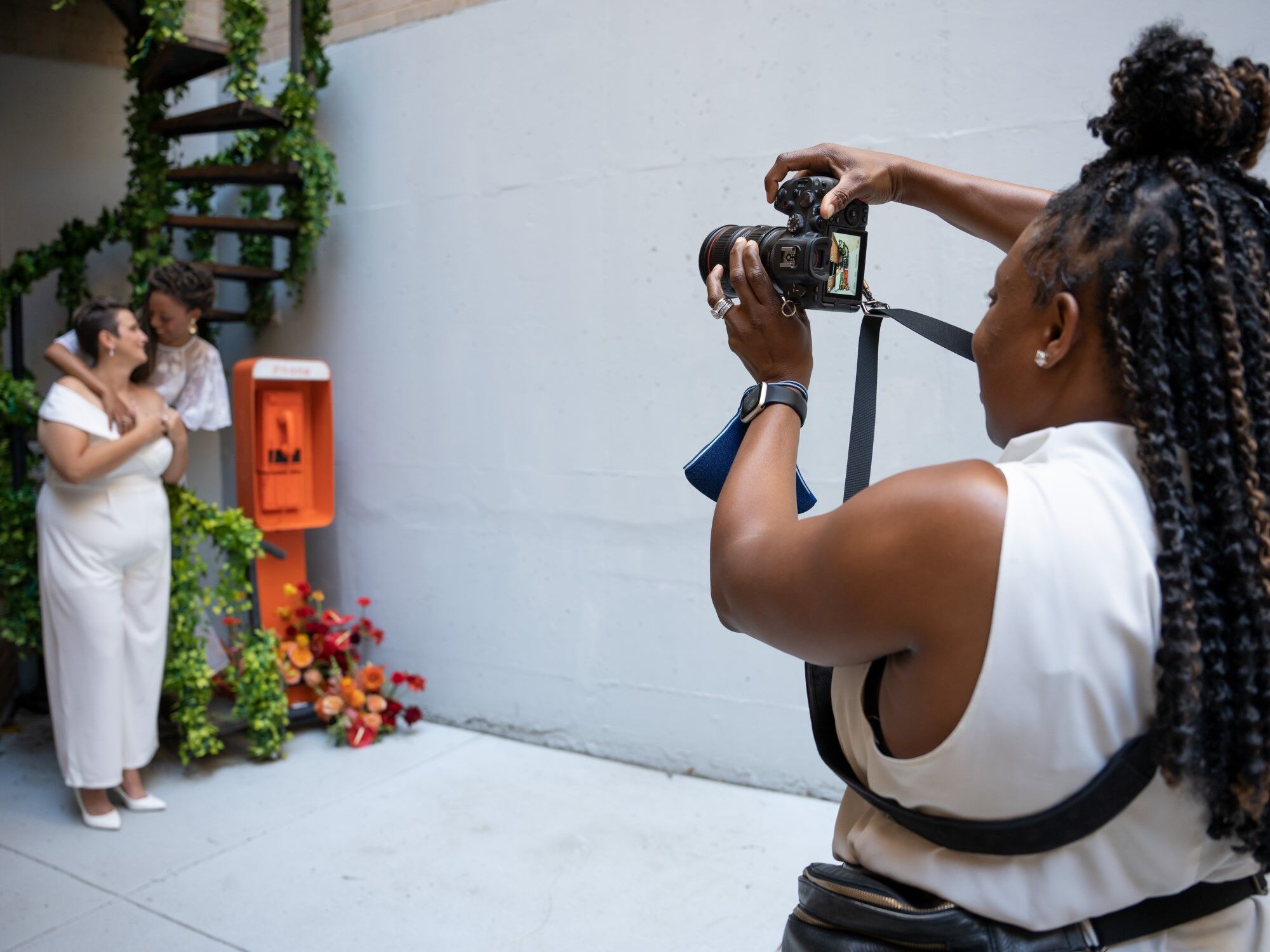 A wedding photographer taking a photo of the happy couple