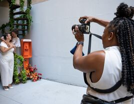 A wedding photographer taking a photo of the happy couple