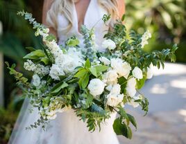 bride holding oversized wedding bouquet with spiral eucalyptus, white roses and other greenery