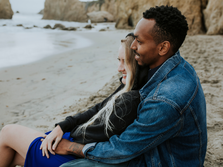 Couple sitting together on California beach