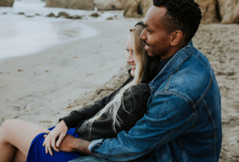 Couple sitting together on California beach