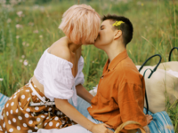 Couple kissing on summer picnic date