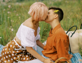 Couple kissing on summer picnic date