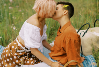 Couple kissing on summer picnic date