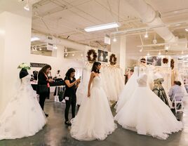 Woman in boutique trying on wedding dresses