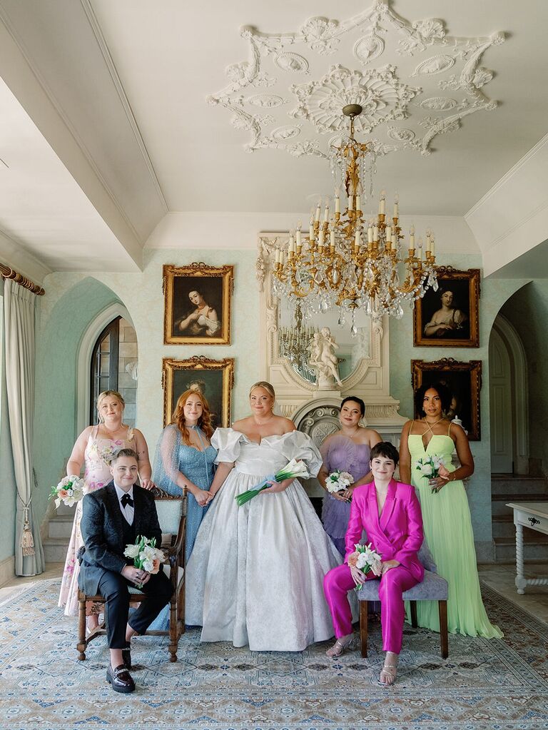 Bridal party wearing dresses and suits in different colors and styles