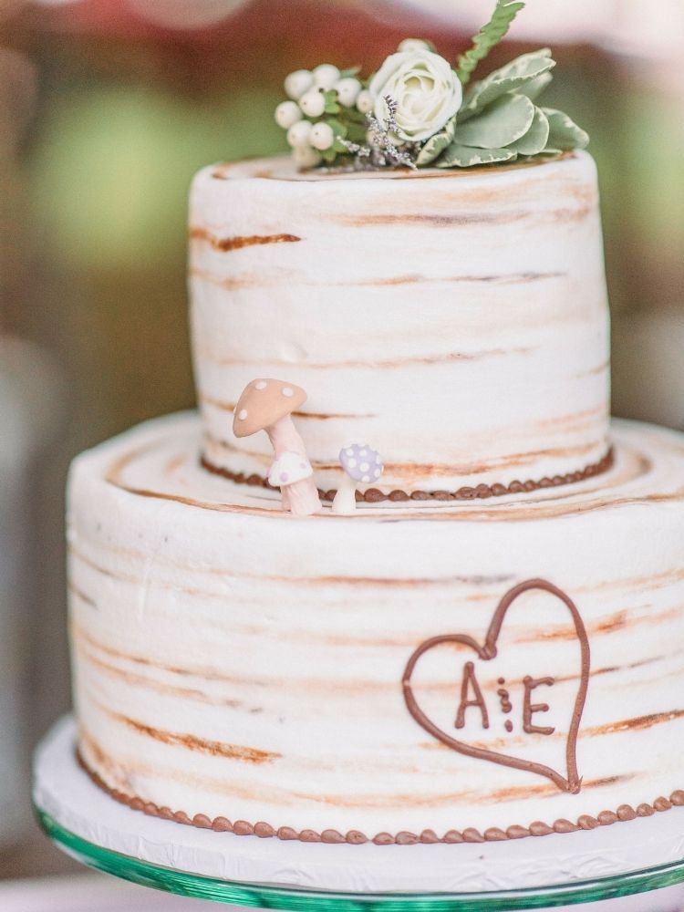 two-tier wedding cake with wood-inspired decorations