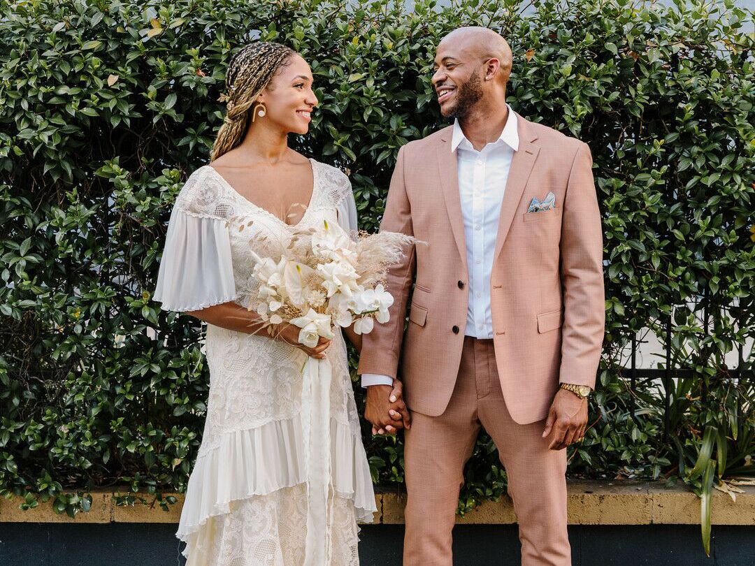 Bride wearing 1970s-style wedding dress with groom