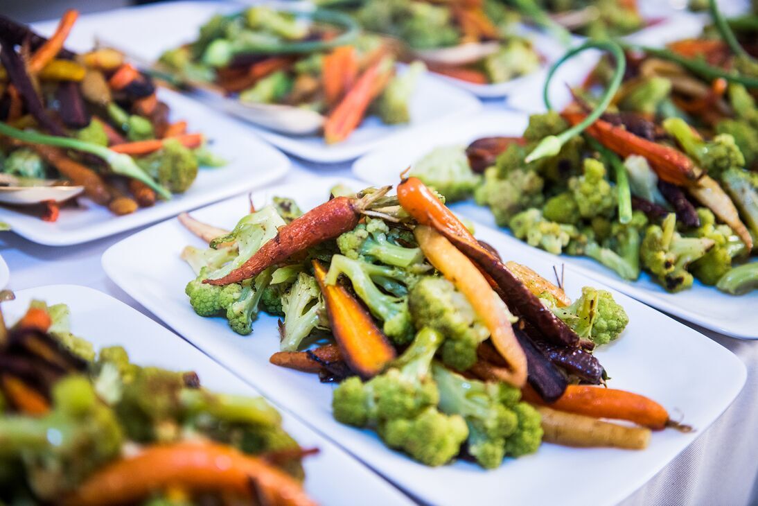 A plate holds a serving of vibrant vegetables. 