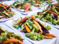 A plate holds a serving of vibrant vegetables. 