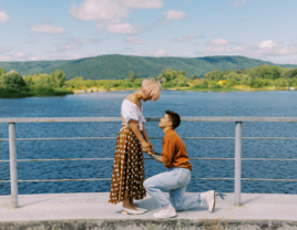 Woman on knee proposing to partner, best places to propose in new york state