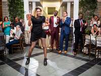 Grooms watching drag performance at wedding reception