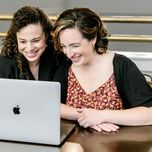 Engaged couple starting their wedding registry on laptop at home