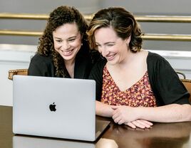 Engaged couple starting their wedding registry on laptop at home