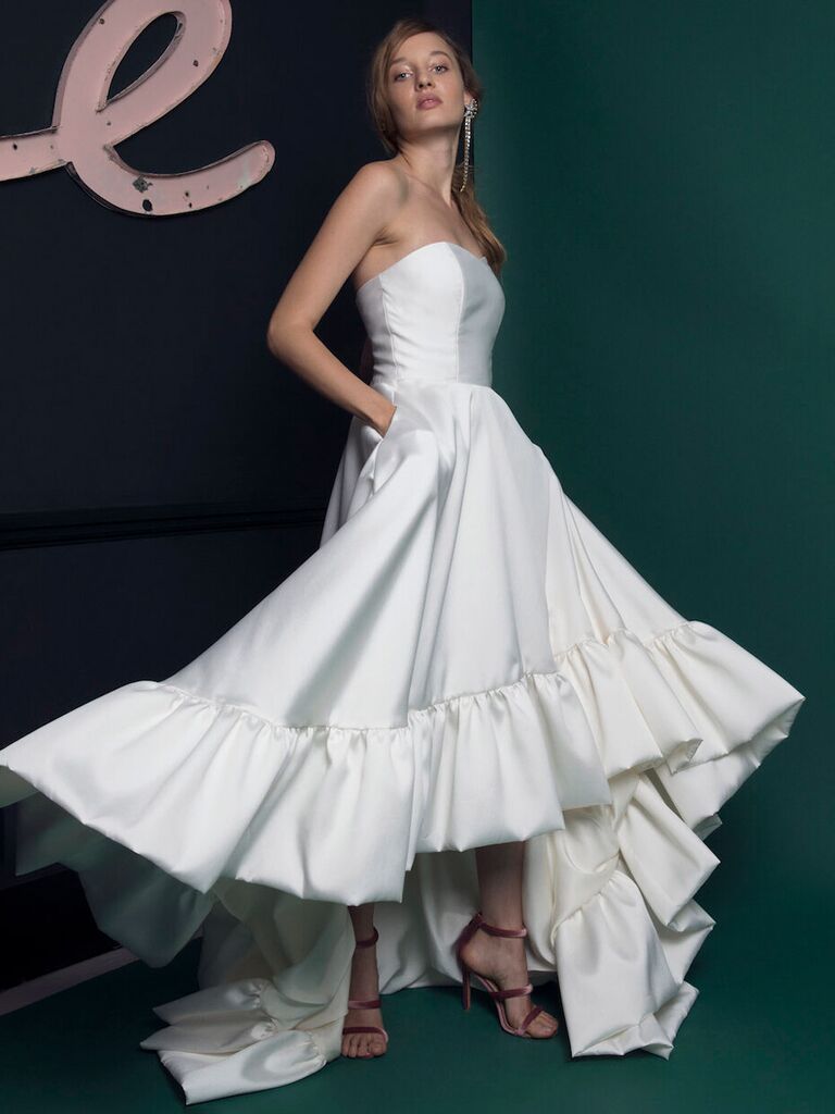 half penny london plain white high low strapless wedding dress with pockets pleated and flowy skirt with ruffle trim