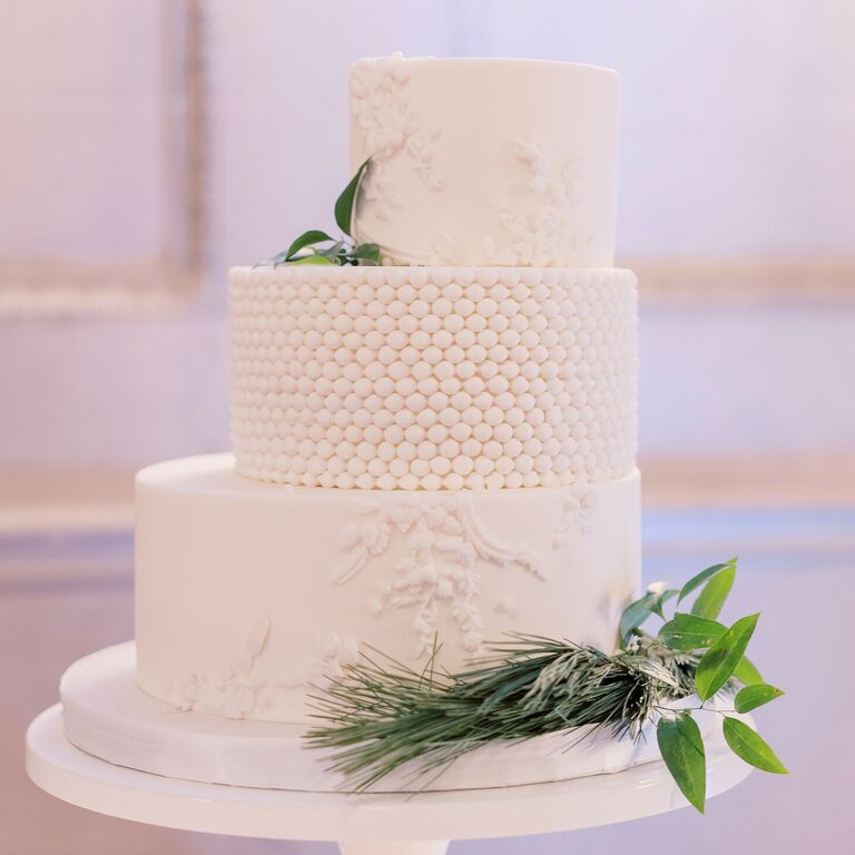 Three-tier white staircase wedding cake