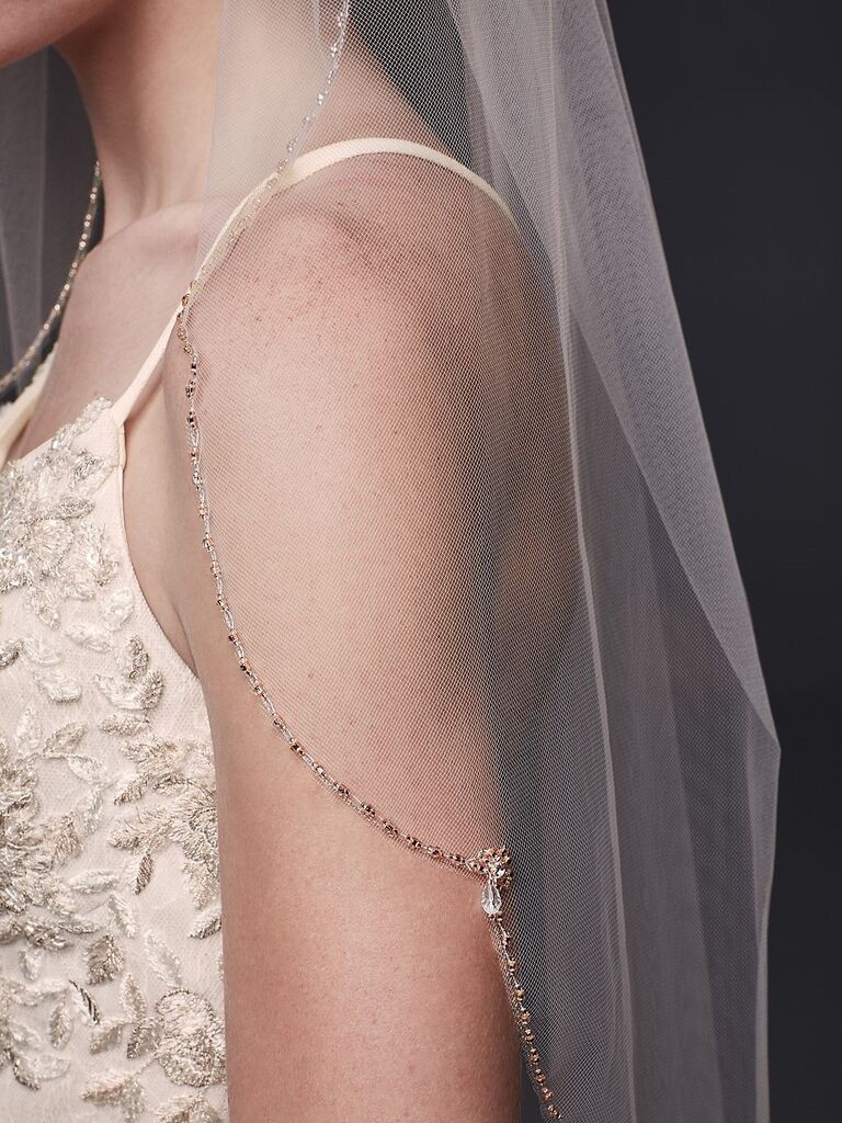 Close up shot of a sheer veil with beaded trim. 