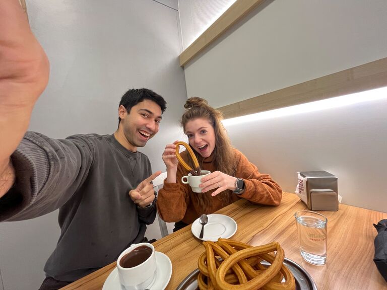 Chloe's first time trying churros con chocolate - the best in Madrid! 🍫 ☕️