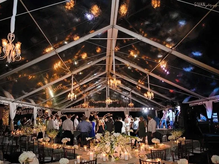 Clear outdoor wedding tent rental with hanging lights from Fenice Events Chair Rentals in Orlando, Florida